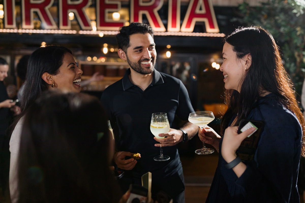 Valon teammates talking over drinks at a team event